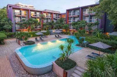 an outdoor pool at a hotel with tables and umbrellas at Holiday Inn Express Phuket Patong Beach Central by IHG in Patong Beach