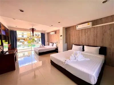 a bedroom with two beds with white towels on them at Baankasemsuk Resort \u822c\u5494 \u6df1\u5bbf in Patong Beach