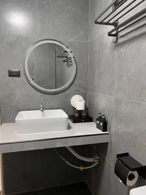a bathroom with a white sink and a mirror at Baankasemsuk Resort \u822c\u5494 \u6df1\u5bbf in Patong Beach