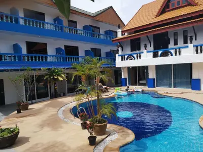 a hotel with a swimming pool in front of a building at Baankasemsuk Resort \u822c\u5494 \u6df1\u5bbf in Patong Beach