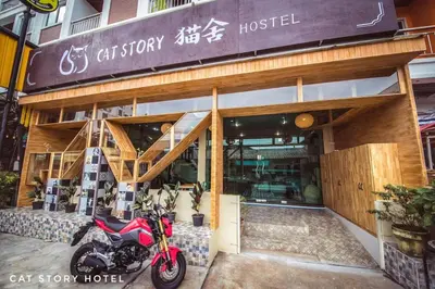 a motorcycle parked in front of a car shop at Cat Story Hotel in Patong Beach