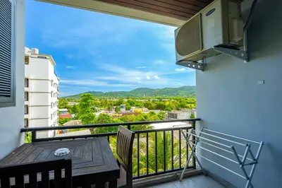a balcony with a table and a view at Anchan Boutique Hotel in Chalong
