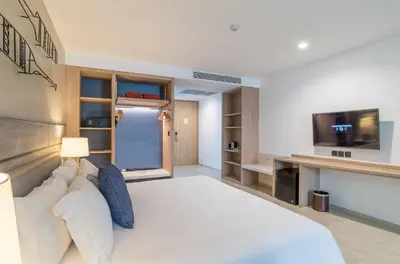 a large bedroom with a large bed and a tv at Centara Ao Nang Beach Resort & Spa Krabi in Ao Nang Beach
