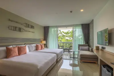 a hotel room with two beds and a living room at Centara Ao Nang Beach Resort & Spa Krabi in Ao Nang Beach