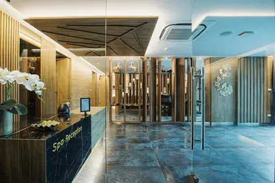 a lobby of a store with a glass wall at Rak Elegant Hotel Patong in Patong Beach