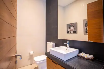 a bathroom with a sink and a toilet at Surin Beach Oceanfront Villa with Ocean and Beach views in Surin Beach
