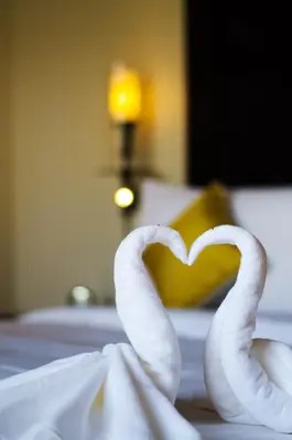two swans making a heart on a bed at Anantara Vacation Club Mai Khao Phuket in Mai Khao Beach