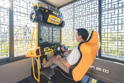 a man sitting in a car machine in a room at Anantara Vacation Club Mai Khao Phuket in Mai Khao Beach