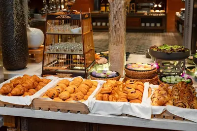 a display of various types of pastries on a table at SAii Laguna Phuket in Bang Tao Beach