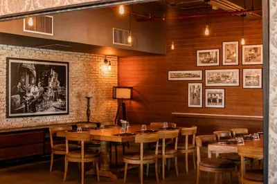 a dining room with wooden tables and chairs at SAii Laguna Phuket in Bang Tao Beach