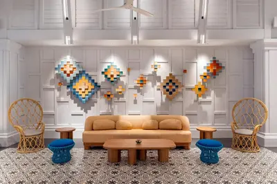 a living room with a couch and two chairs at SAii Laguna Phuket in Bang Tao Beach