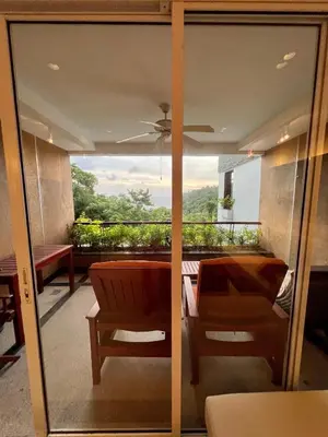 a glass door with a view of a balcony at Luxury Apartment Kata Beach The Accenta in Kata Beach
