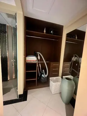 a walk in closet with a large green vase at Luxury Apartment Kata Beach The Accenta in Kata Beach