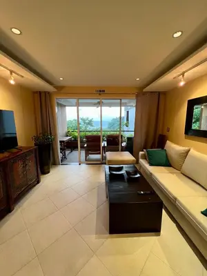 a living room with a couch and a table at Luxury Apartment Kata Beach The Accenta in Kata Beach