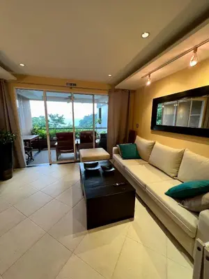 a living room with a couch and a table at Luxury Apartment Kata Beach The Accenta in Kata Beach