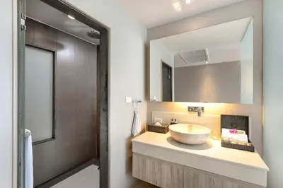 a bathroom with a sink and a mirror at Cape Sienna Phuket Gourmet Hotel & Villas - SHA Extra Plus in Kamala Beach