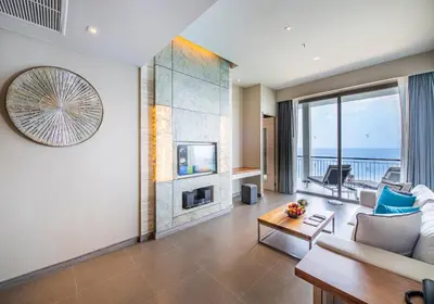 a living room with a view of the ocean at Cape Sienna Phuket Gourmet Hotel & Villas - SHA Extra Plus in Kamala Beach