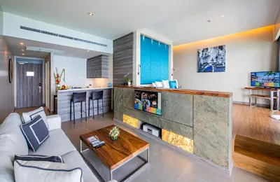 a living room with a couch and a table at Cape Sienna Phuket Gourmet Hotel & Villas - SHA Extra Plus in Kamala Beach