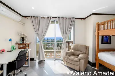 a bedroom with a bed and a desk and a chair at Waterfront Karon Beach by PHR in Karon Beach