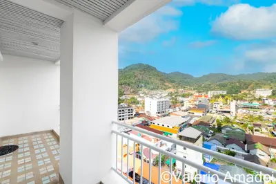 a balcony with a view of a city at Waterfront Karon Beach by PHR in Karon Beach