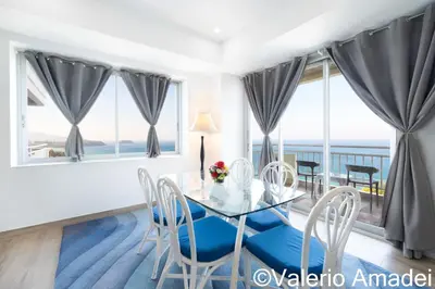 a dining room with a glass table and chairs at Waterfront Karon Beach by PHR in Karon Beach