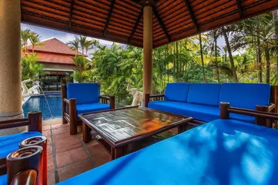 a patio with a table and chairs and a pool at VILLA TOGIAN Private Pool Naiharn beach in Rawai Beach
