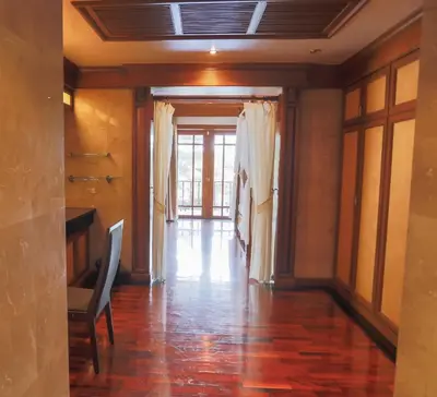 a hallway of a house with a table and a chair at Lawootrip Villa in Patong Beach