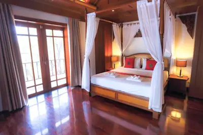 a bedroom with a bed with a canopy at Lawootrip Villa in Patong Beach