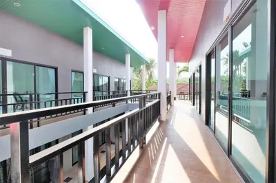 an empty hallway of a building with windows at Tina Boutique Resort in Thalang