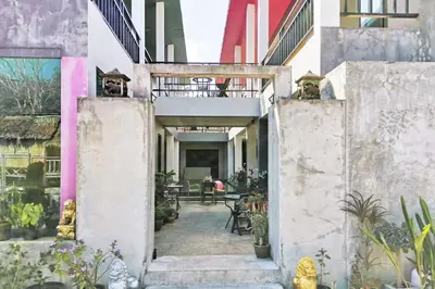 a courtyard of a building with tables and plants at Tina Boutique Resort in Thalang