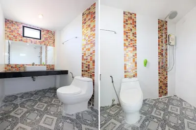 a bathroom with a toilet and a sink at Tina Boutique Resort in Thalang