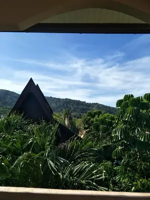 a view from a window of a house with plants at Thalassa in Nai Harn Beach