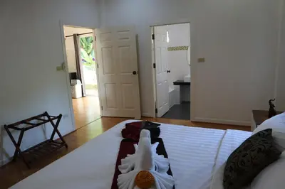 a bedroom with a bed with a robe on it at Relax private Pool Villas - 4 bedroom villas in Ao Nang Beach
