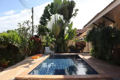a swimming pool in the middle of a garden at Relax private Pool Villas - 4 bedroom villas in Ao Nang Beach