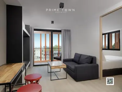 a living room with a couch and a bed at PRIME TOWN - Posh & Port Hotel PHUKET in Phuket Town