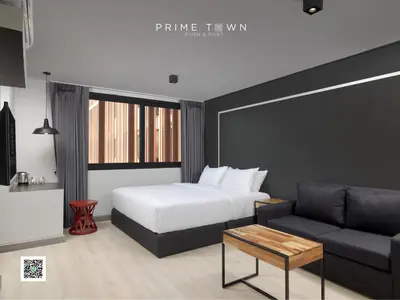 a bedroom with a bed and a couch at PRIME TOWN - Posh & Port Hotel PHUKET in Phuket Town