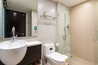 a bathroom with a sink and a toilet and a shower at Emerald Terrace Resort in Patong Beach