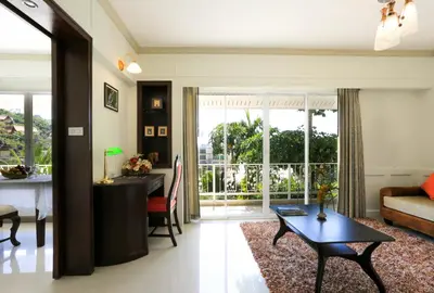 a living room with a table and a dining room at Naka Resort in Kamala Beach