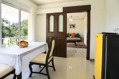 a dining room with a table with a bowl of fruit at Naka Resort in Kamala Beach