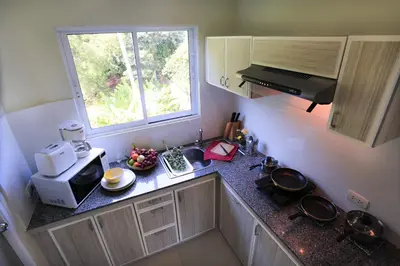 a small kitchen with a sink and a microwave at Naka Resort in Kamala Beach