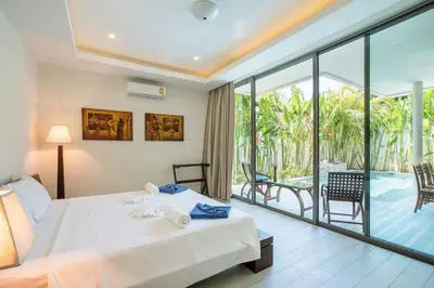 a bedroom with a bed and a balcony with a pool at VILLA Bangka 4BR Private pool villa Rawai in Rawai Beach