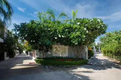 a building with trees on the side of a street at VILLA Bangka 4BR Private pool villa Rawai in Rawai Beach