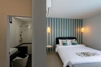 a hotel room with a bed and a bathroom at Lespalm Taraburi Pool Villa SHA Plus in Thalang