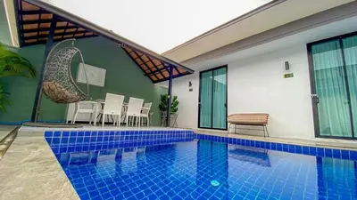 a swimming pool with blue tiles in a house at Lespalm Taraburi Pool Villa SHA Plus in Thalang