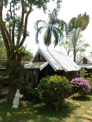 a small house with a statue in front of it at Le Passe-Temps in Tha Lane Bay