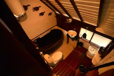 a small bathroom with a toilet and a sink at Le Passe-Temps in Tha Lane Bay