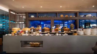 a kitchen with a counter with dishes and a bear on it at Holiday Inn Resort Phuket, an IHG Hotel in Patong Beach