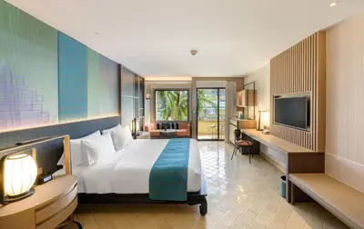 a hotel room with a bed and a television at Holiday Inn Resort Phuket, an IHG Hotel in Patong Beach