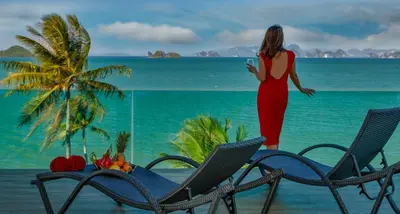 a woman in a red dress standing on the beach at Saengsuree Villas Koh Yao Yai in Ko Yao Yai