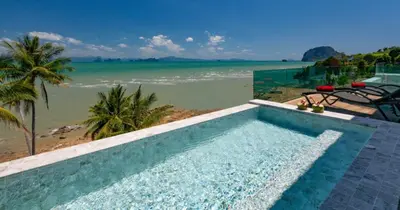 a swimming pool with a view of the beach at Saengsuree Villas Koh Yao Yai in Ko Yao Yai